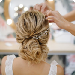 hairdresser-woman-weaving-braid-hair-wedding-styling 1